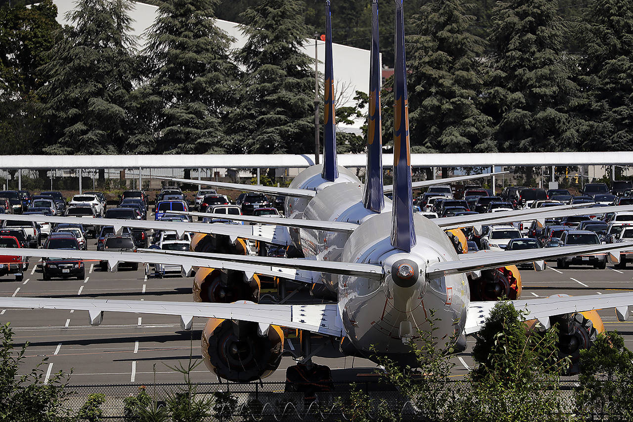Three grounded Boeing 737 MAX airplanes, built for Icelandair, sit parked in a lot normally used for cars in an area adjacent to Boeing Field on Aug. 15 in Seattle. (AP Photo/Elaine Thompson)