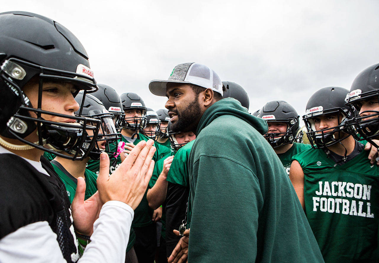 First-year Jackson head coach Mason Siddick gets the team together in a huddle before its season-opening fall practice Wednesday in Mill Creek. (Olivia Vanni / The Herald)