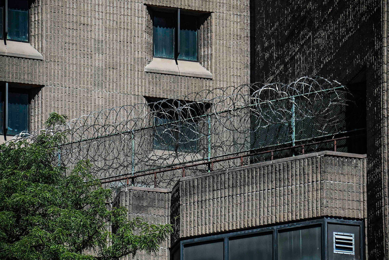 Razor-wire fencing stretches along a wall at the Metropolitan Correctional Center in New York where financier Jeffrey Epstein died while awaiting trial on sex-trafficking charges. (Associated Press)