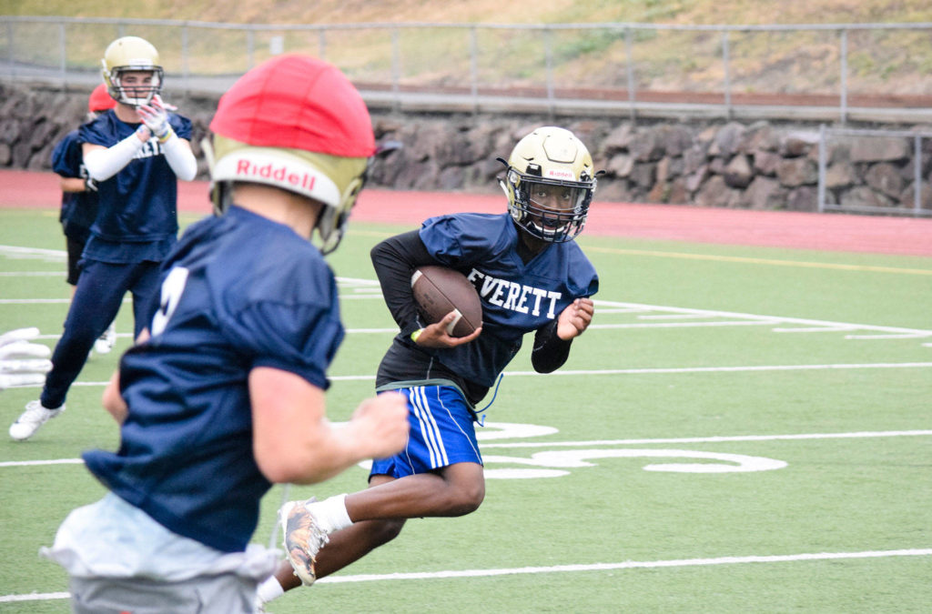 Everett’s Jemyre Reed runs to the end zone after intercepting a pass during practice at Everett Memorial Stadium on Wednesday, Aug. 21. (Katie Webber / The Herald)
