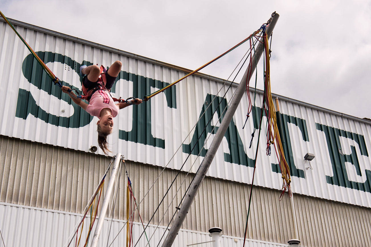 Molly Hiller, 9, performs a back flip on the Power Jump during the opening day of the Evergreen State Fair on Thursday, Aug. 22, 2019 in Monroe, Wash. (Andy Bronson / The Herald)