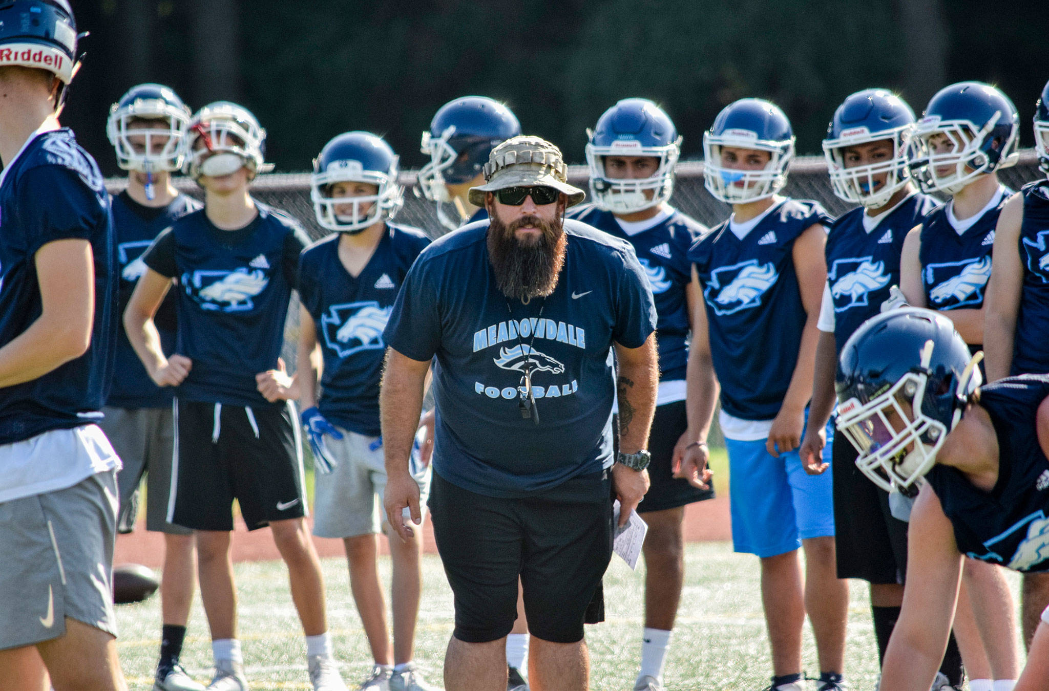 Meadowdale’s head coach James Harmon watches his team while practicing plays at Meadowdale High School on Thursday, Aug. 22. (Katie Webber / The Herald)