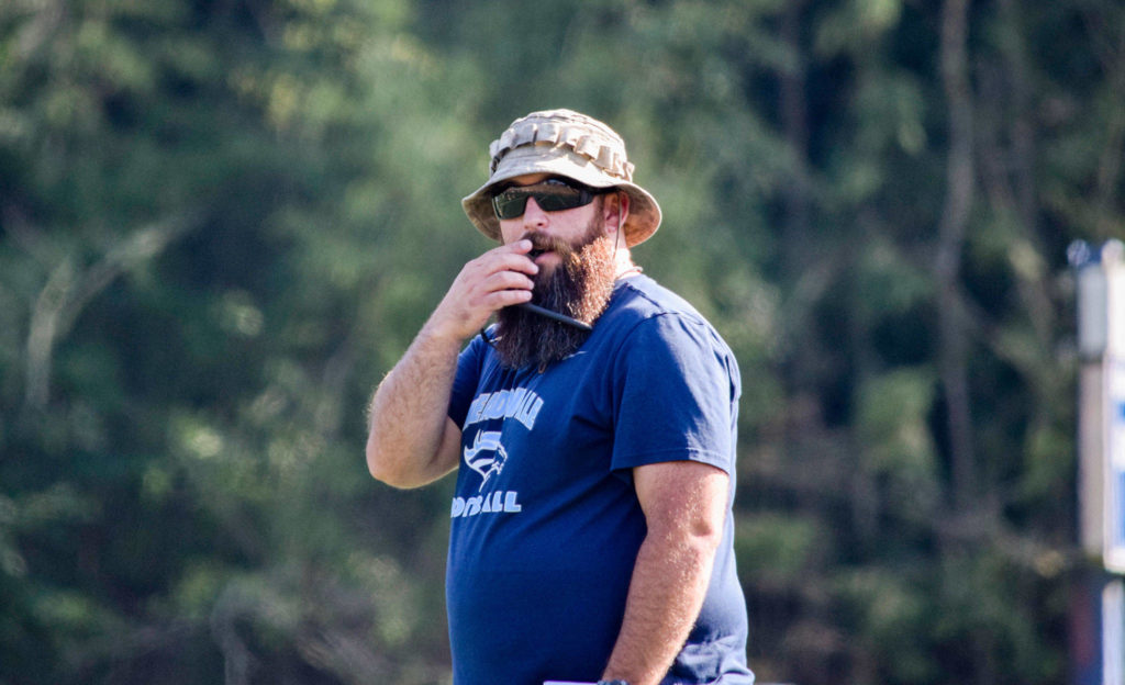 Meadowdale’s head coach James Harmon blows the whistle in-between plays at Meadowdale High School on Thursday, Aug. 22. (Katie Webber / The Herald)
