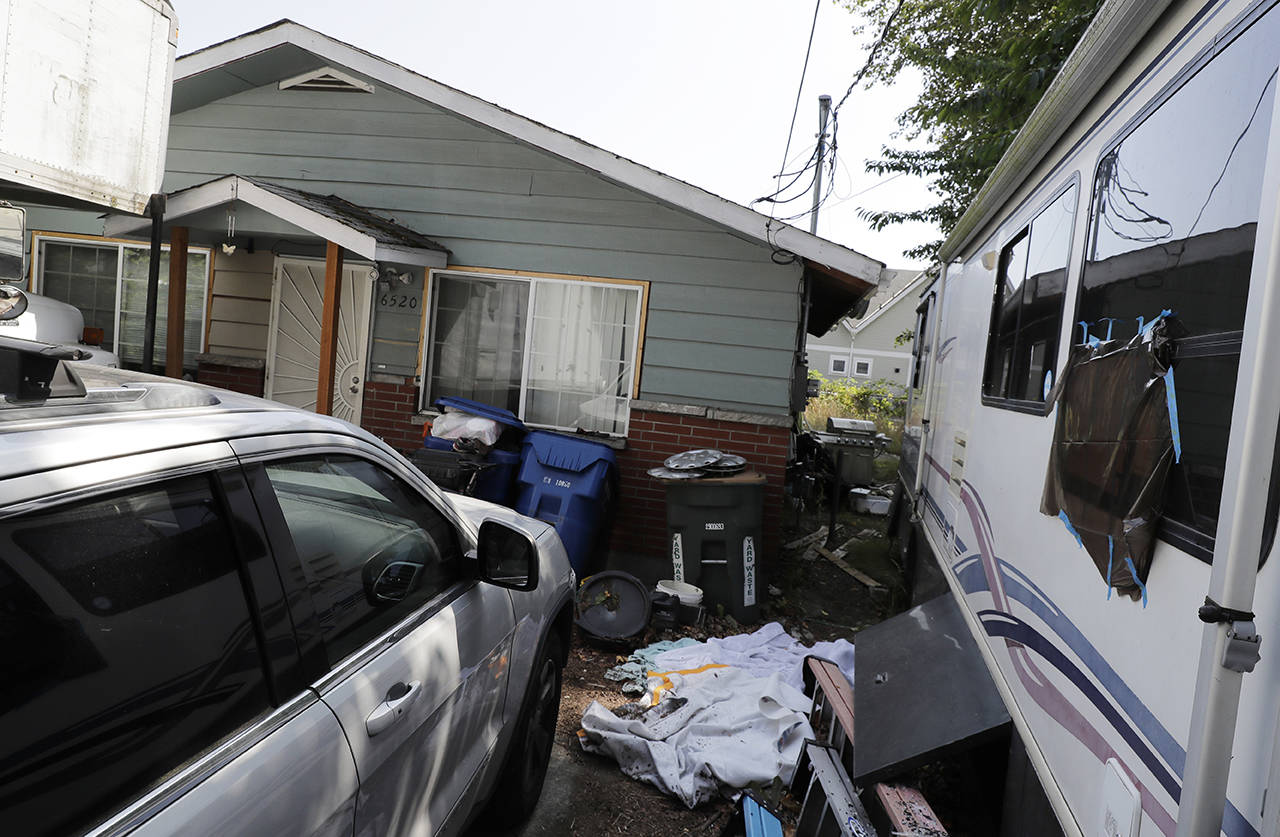In this July 31 photo, vehicles are parked outside the home of Paige A. Thompson, who uses the online handle “erratic,” in Seattle. Thompson was arrested last month after the FBI said she obtained personal information from more than 100 million Capital One credit applications. (AP Photo/Ted S. Warren, File)