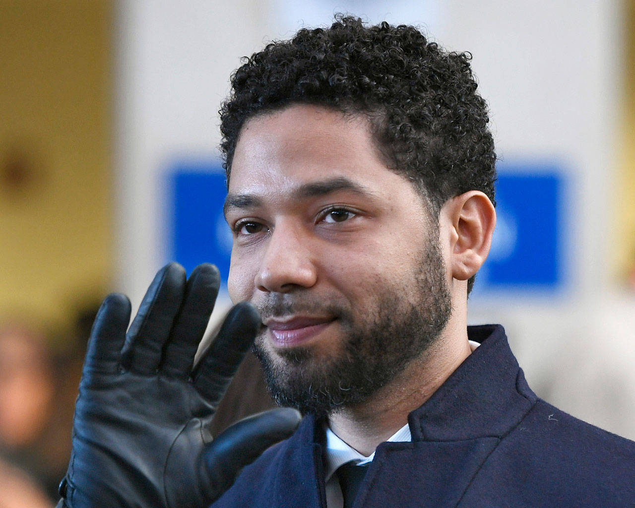 Actor Jussie Smollett waves to supporters before leaving Cook County Court in Chicago on March 26, after his charges were dropped. An Illinois judge appointed a special prosecutor to look into why state prosecutors abruptly dropped those charges. (AP Photo/Paul Beaty, File)