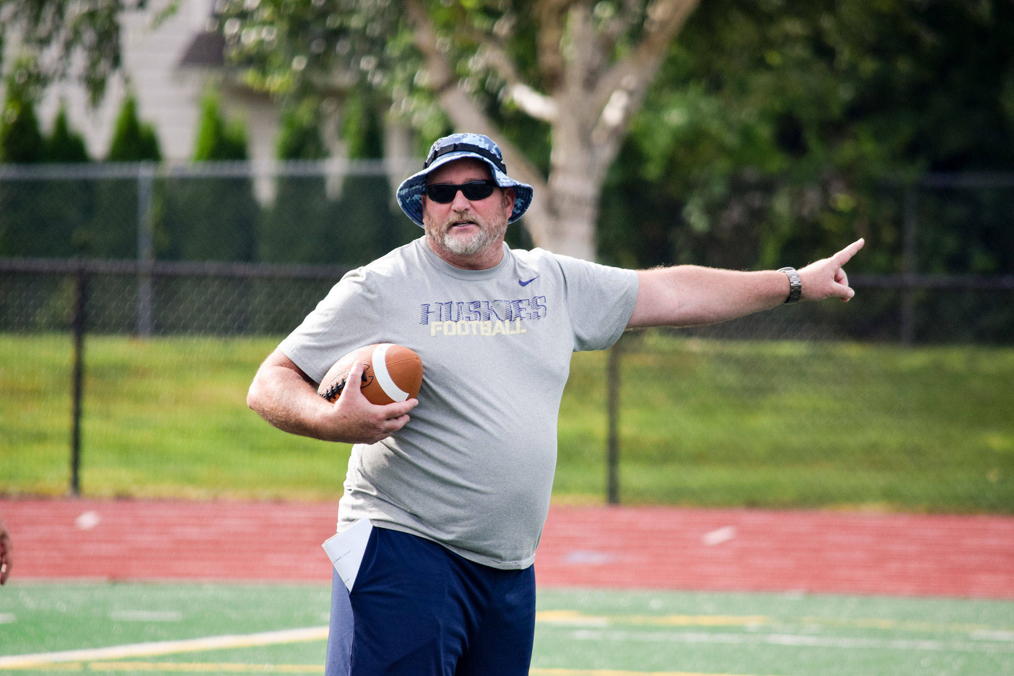 Sultan head coach Rick Rudd points as he explains a drill to his team during practice on Aug. 23, 2019, at Sultan High School. (Katie Webber / The Herald)