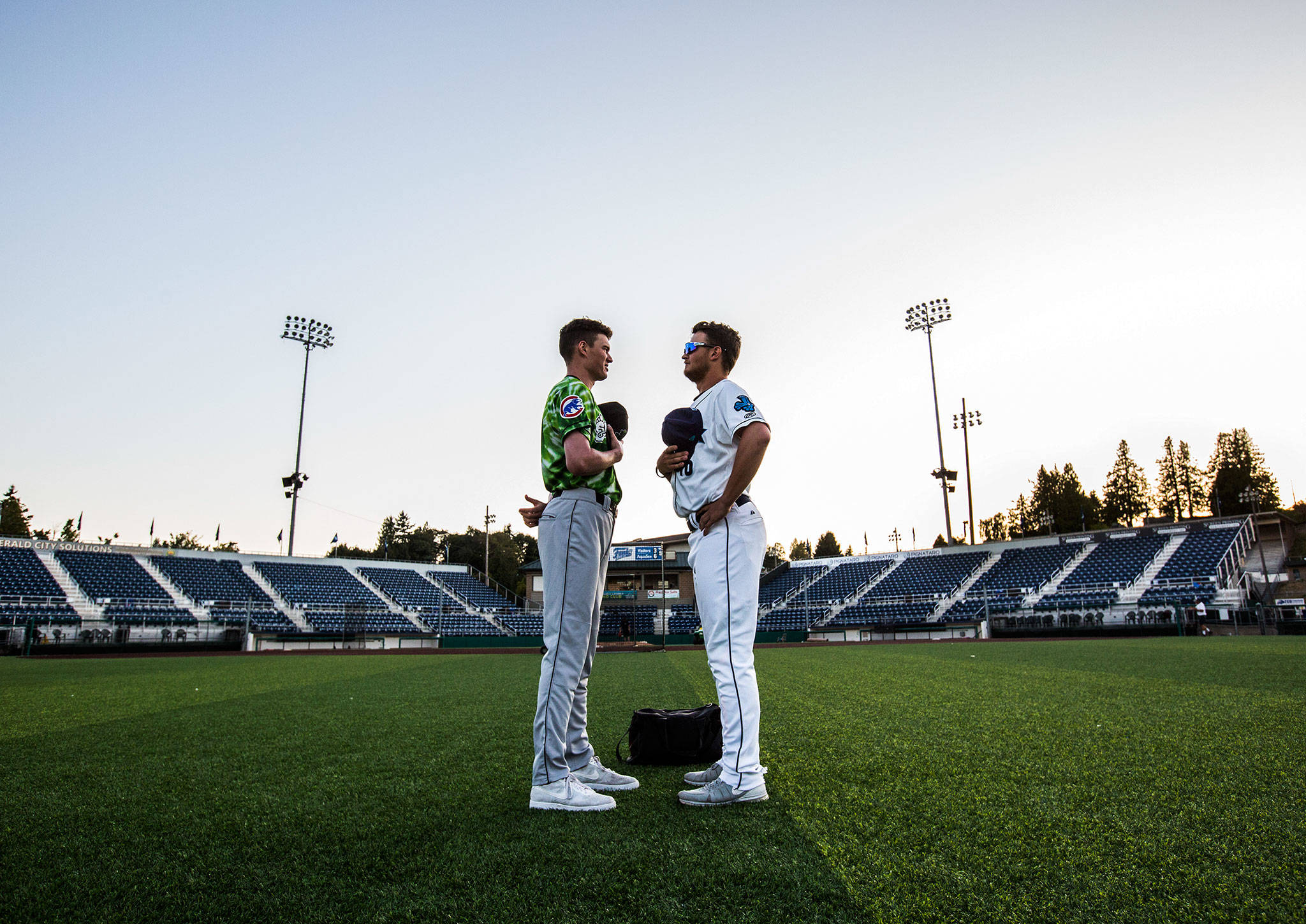 Everett’s Garrett Westberg (right) and Eugene’s Chris Allen continue their national-anthem standoff an hour after Sunday’s game at Funko Field in Everett. (Olivia Vanni / The Herald)