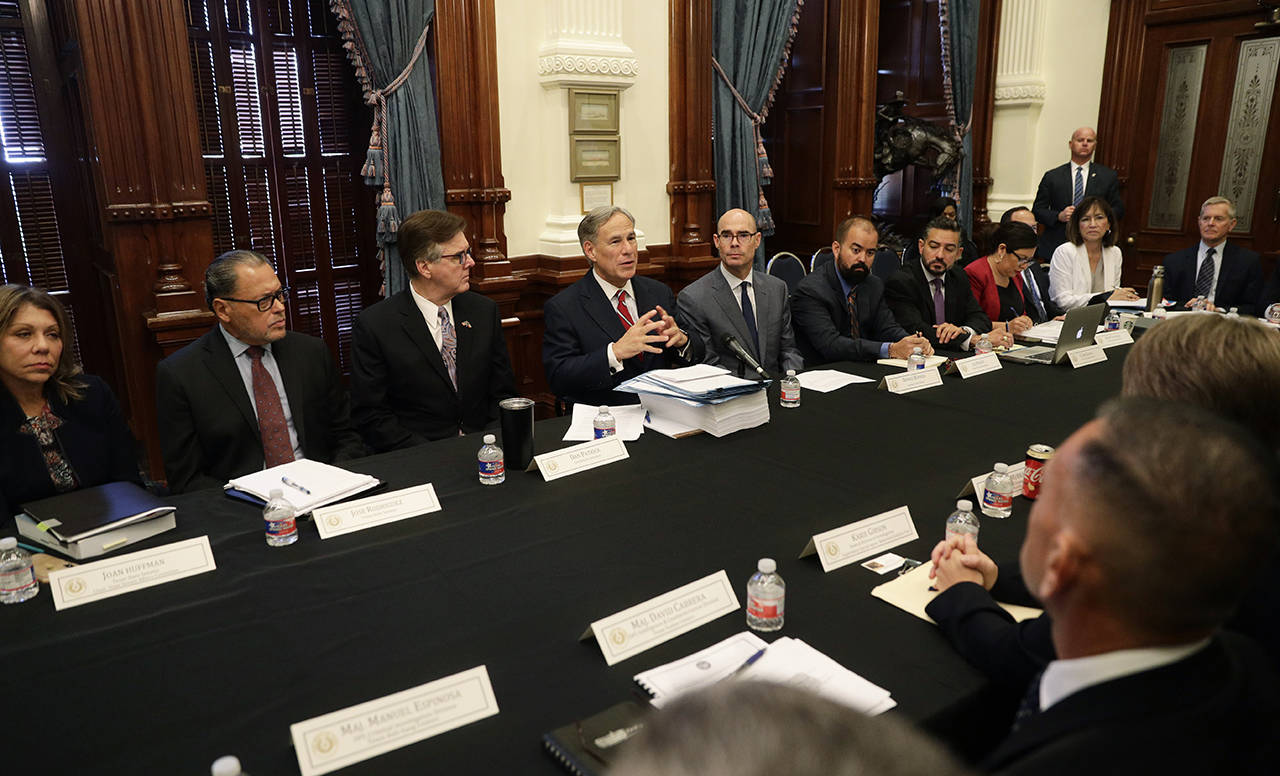 Texas Gov. Greg Abbott (top center) makes opening statements during a round table discussion,Thursday in Austin, Texas. Abbott is meeting in Austin with officials from Google, Twitter and Facebook as well as officials from the FBI and state lawmakers to discuss ways of combatting extremism in light of the recent mass shooting in El Paso that reportedly targeted Mexicans. (AP Photo/Eric Gay)
