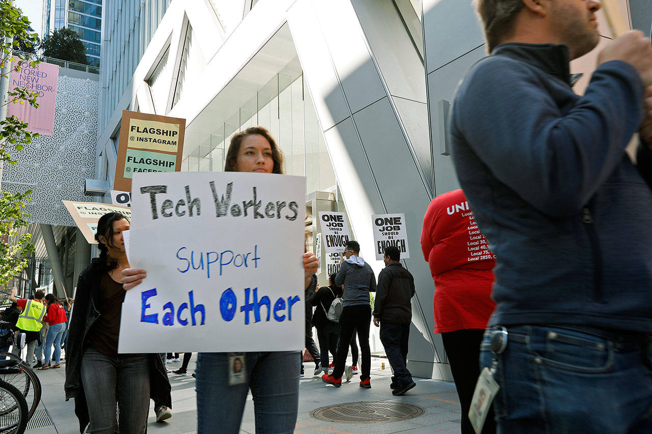 Tech workers march July 16 to support Facebook’s cafeteria workers, who were rallying for a new contract with their company Flaghship in San Francisco. (AP Photo/Samantha Maldonado)