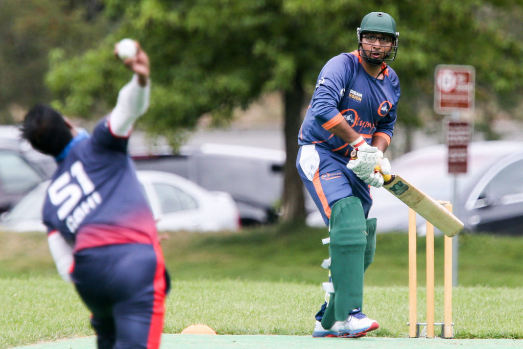 Abhishek Kumar bowls against Adnan Sohail during an Aug. 18 NorthWest Cricket League match at McCollum Park in Everett. (Kevin Clark / The Herald)
