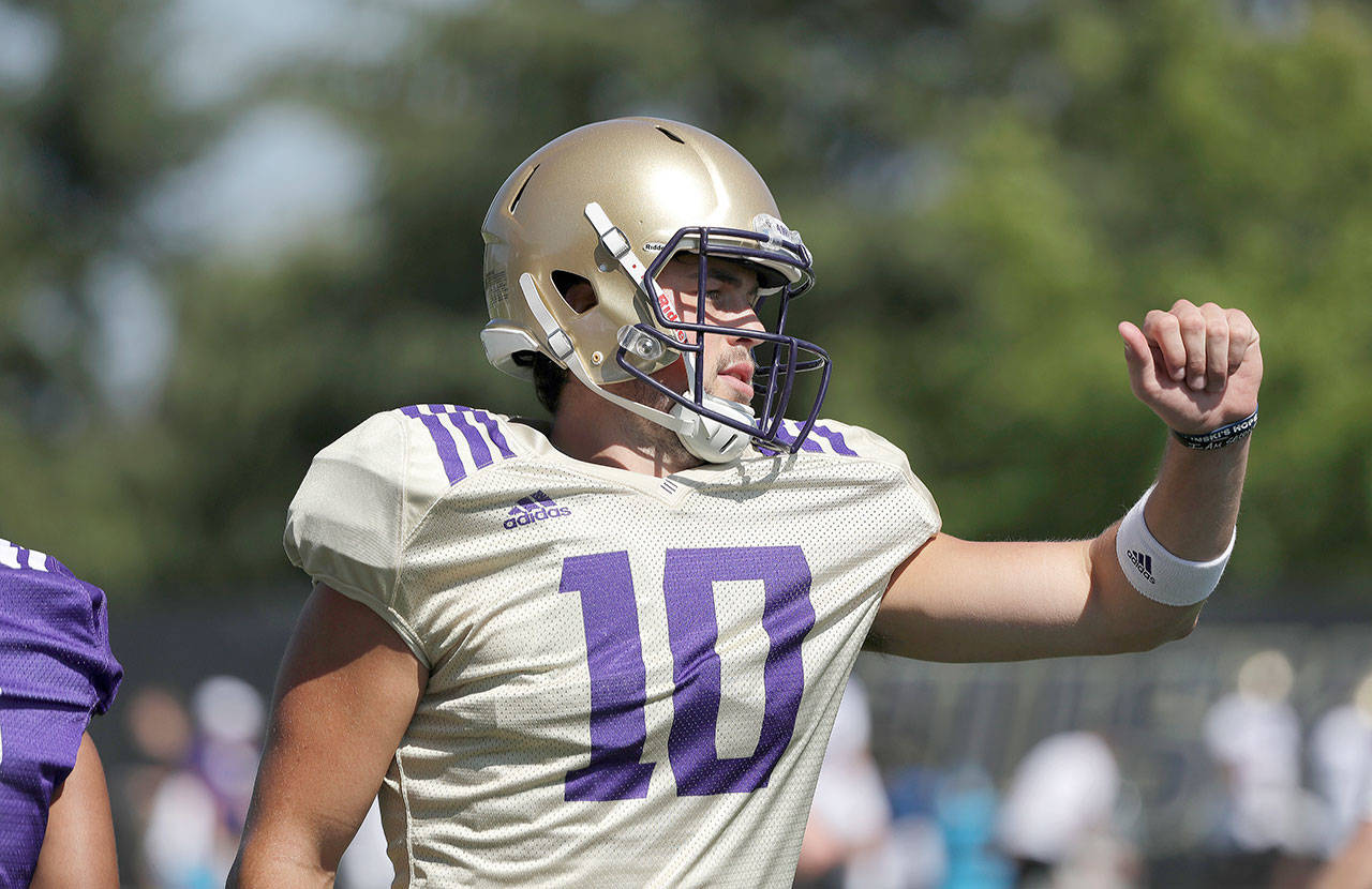Washington quarterback Jacob Eason, a Lake Stevens graduate, motions to a teammate during a practice on Aug. 6, 2019, in Seattle. (AP Photo/Elaine Thompson)