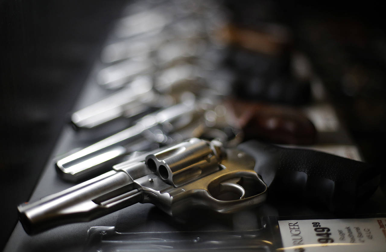 In this 2018 photo, handguns for sale are lined up in a display case at Frontier Justice in Lee’s Summit, Missouri. (AP Photo/Charlie Riedel, file)