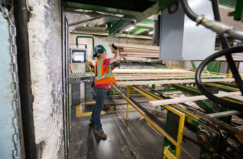 Jessica Ward runs a stacker at Hampton Mill on Thursday in Darrington. The mill is asking for more trees from Commissioner of Public Lands Hilary Franz. (Andy Bronson / The Herald)
