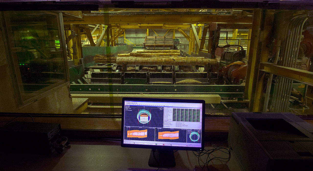 A computer measures and calculates how much product can be made from each log at the Hampton Mill. (Andy Bronson / The Herald)
