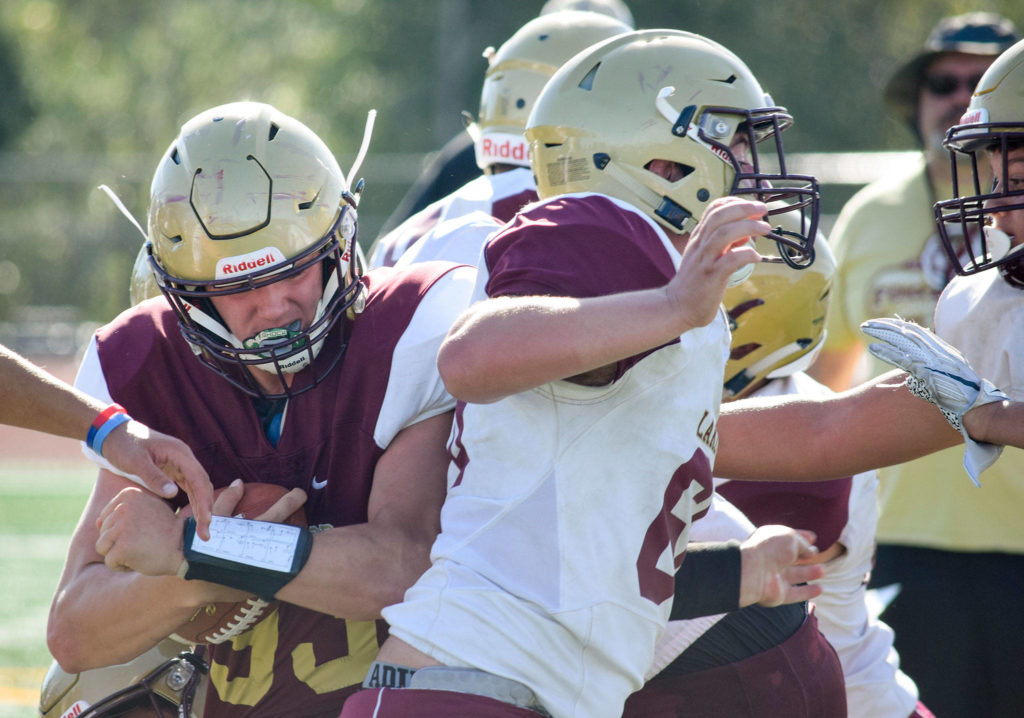 Senior Brandt Starkey pushes into the linemen on Aug. 28, 2019, at Lakewood High School in Arlington. (Katie Webber / The Herald)
