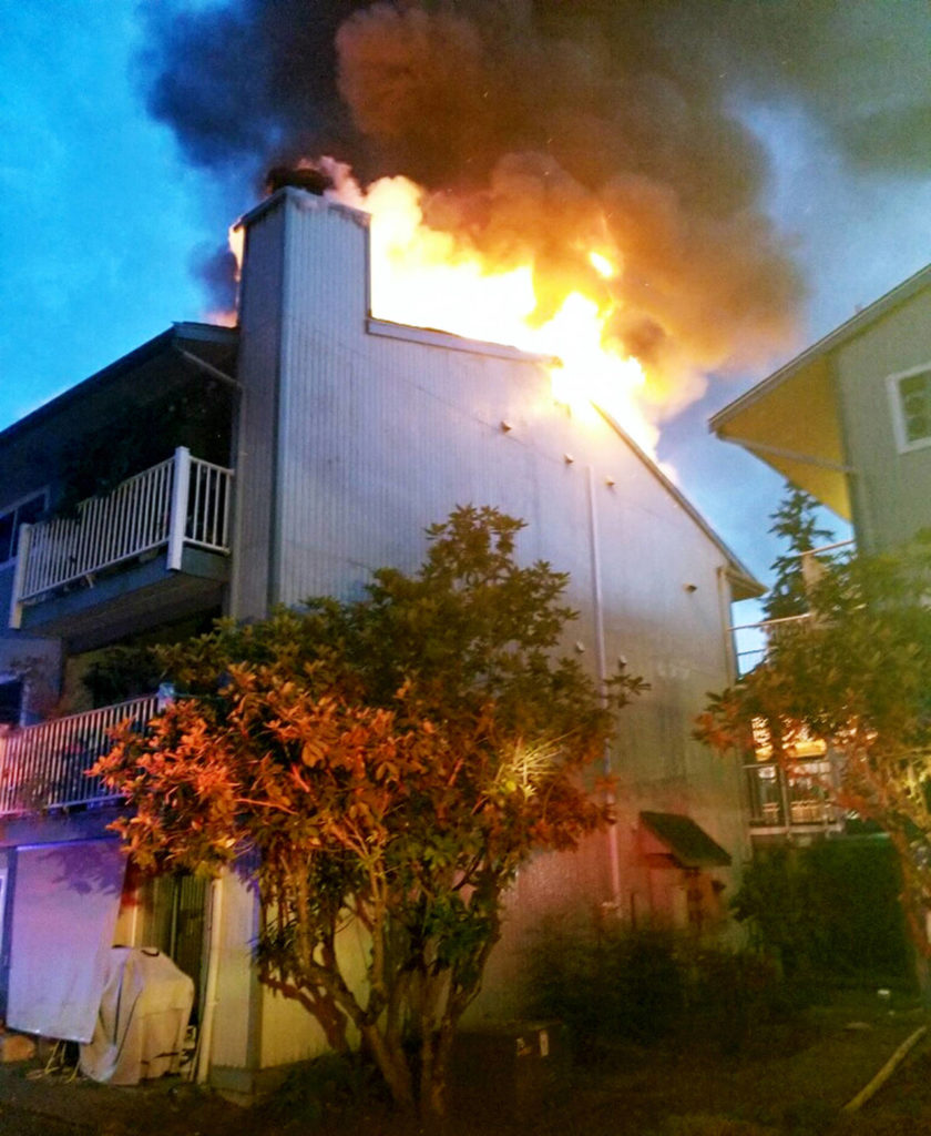 Fire crews were called twice to the same condominium building in Lynnwood. The second time they confronted large flames coming from the attic. (South County Fire)

