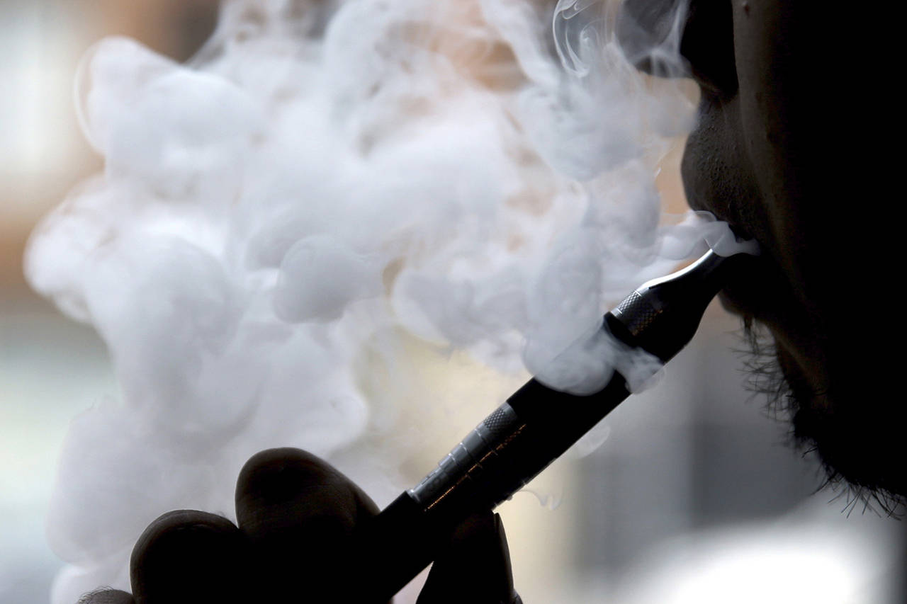 In 2014 photo, a man smokes an electronic cigarette in Chicago. (AP Photo/Nam Y. Huh, File)