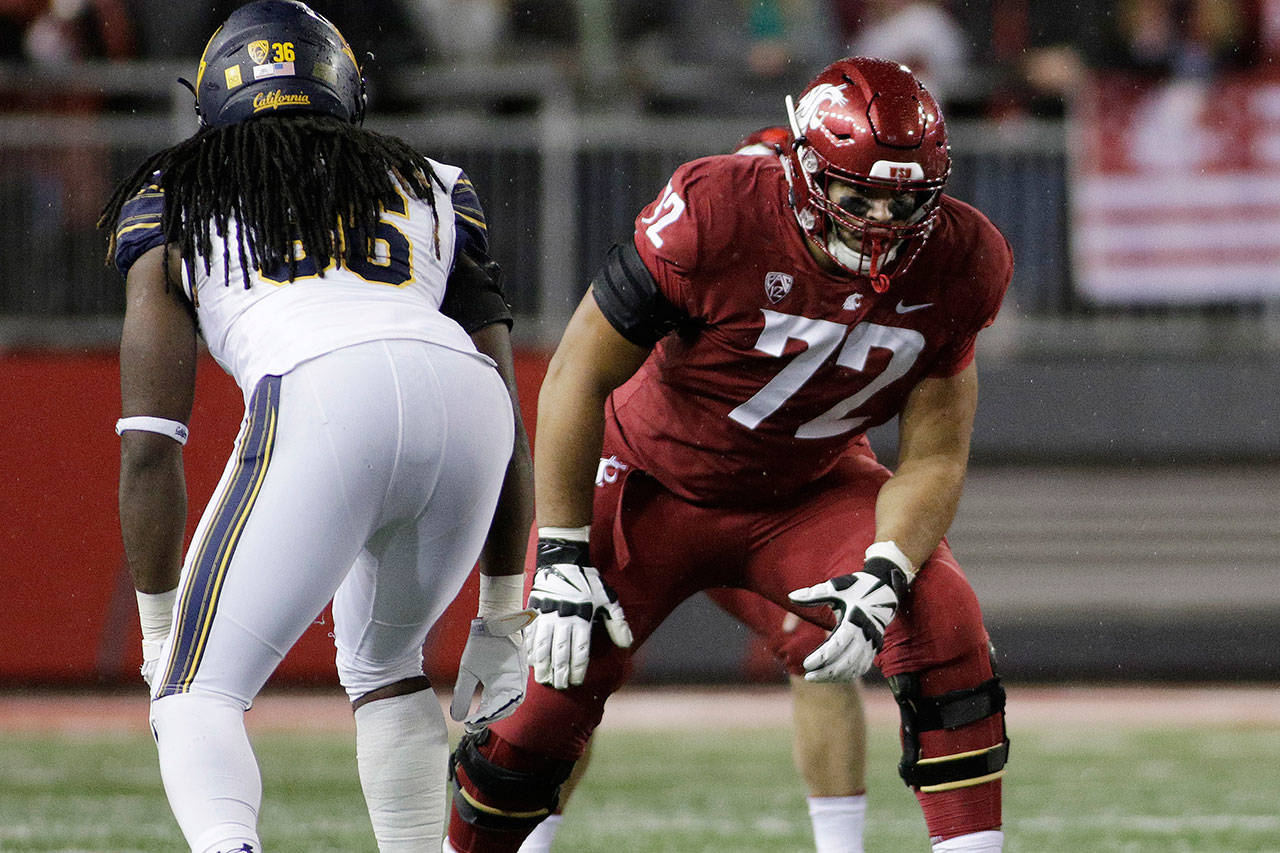 Washington State offensive lineman Abraham Lucas (right) lines up for a play during the second half of a game against California on Nov. 3, 2018, in Pullman. (AP Photo/Young Kwak)