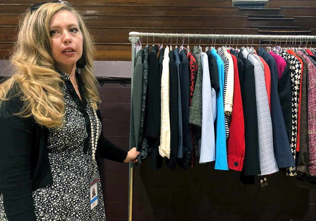 Mary Anne Dillon, executive director of the YWCA Snohomish branch, showcases the nonprofit’s Working Wardrobe program, which offers free business attire to homeless or low-income women. (Janice Podsada / The Herald)
