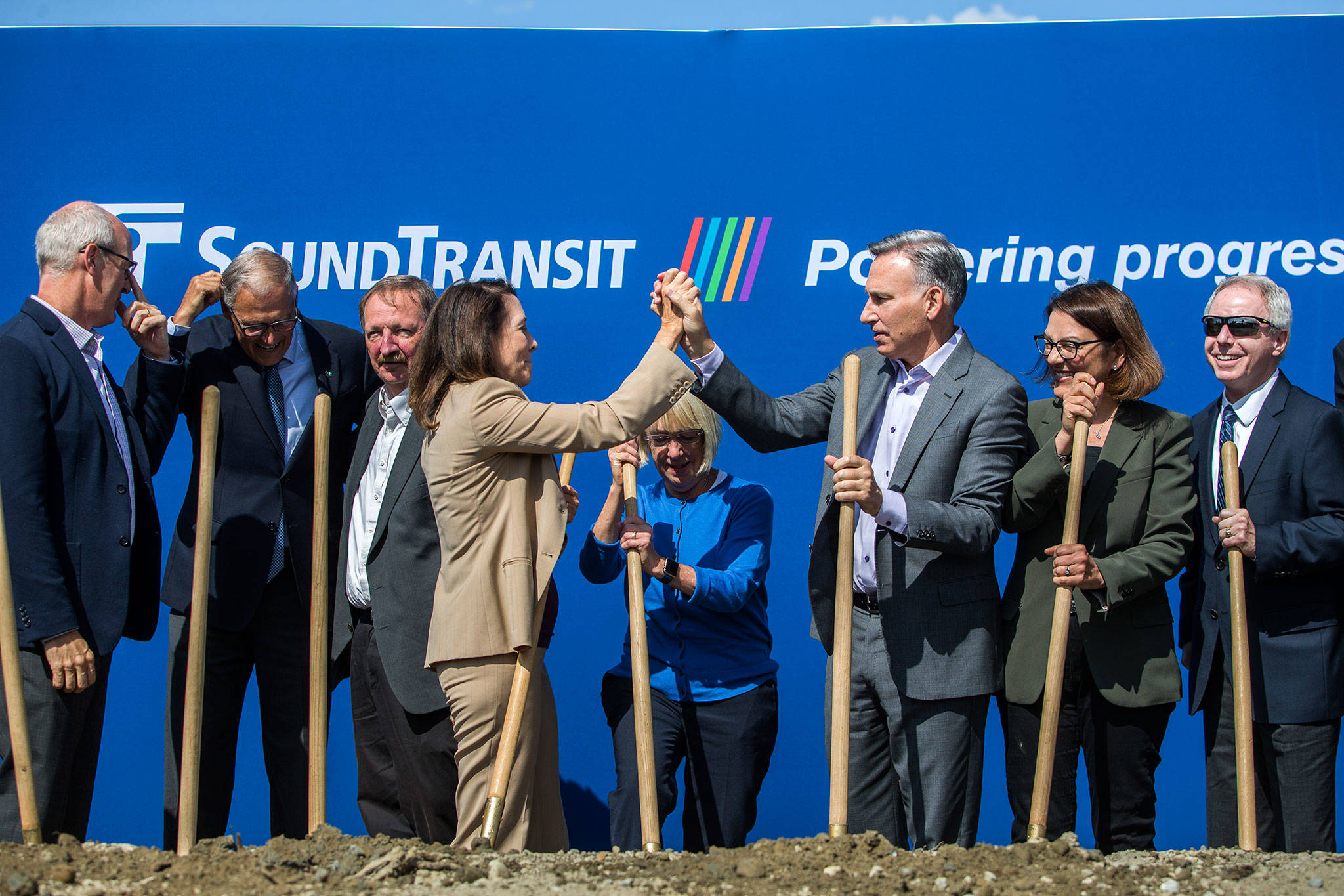 U.S. Sen. Maria Cantwell (fourth from left) high-fives King County Executive Dow Constantine after the Link light rail extension groundbreaking on Tuesday in Lynnwood. With them are, from left, U.S. Rep. Rick Larsen, Gov. Jay Inslee, Snohomish County Executive Dave Somers, U.S. Sen. Patty Murray, U.S. Rep. Suzan DelBene and Snohomish County Councilman Terry Ryan. (Olivia Vanni / The Herald)