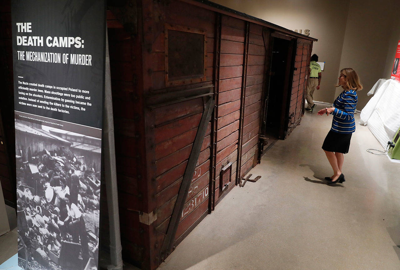 Dallas Holocaust and Human Rights Museum President and CEO Mary Pat Higgins walks through a World War II-era train box car similar to those used to transport Jews to concentration camps. (AP Photo/Tony Gutierrez)