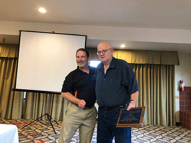 Richard Short (right) is presented with the Dave Duvall Meritorious Award by Granite Falls High School athletic director Joey Johnson (left) at an Aug. 29 ceremony in Mount Vernon. (Photo provided)