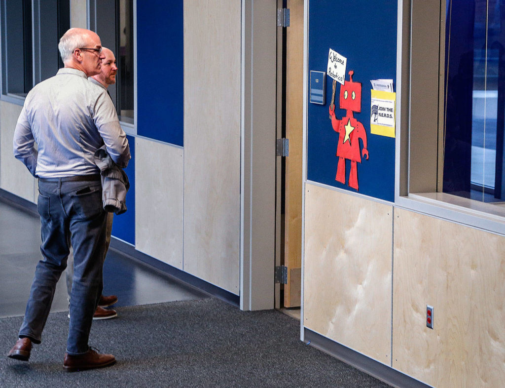 While touring Everett’s North Middle School on the first day of classes Wednesday, Congressman Rick Larsen (left) and Principal Mitch Entler do an about-face to watch a robotics class through through the open door. (Dan Bates / The Herald)
