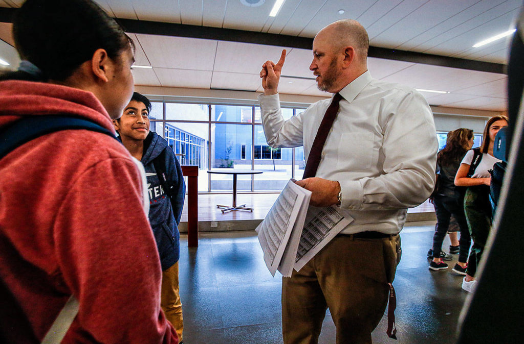 On the first day of school at North Middle School on Wednesday, Principal Mitch Entler points kids in the right direction to their classrooms. In many cases, that will mean going up a giant stairway to the second floor of their spacious new building. (Dan Bates / The Herald)
