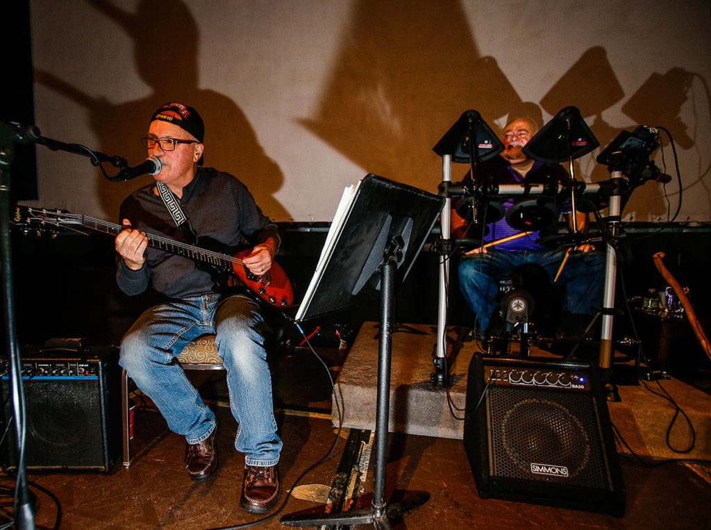 At the Northwest Music Hall, in an old Everett Mall movie theater, Vietnam veteran Mel Grewing (left) and Scott Alexander on drums practice in 2015 as part of a jam band, a program of the Snohomish County Music Project. The nonprofit recently moved from the Everett Mall to its new home, the former Purdy & Walters with Cassidy Funeral Home in downtown Everett. (Dan Bates / The Herald)
