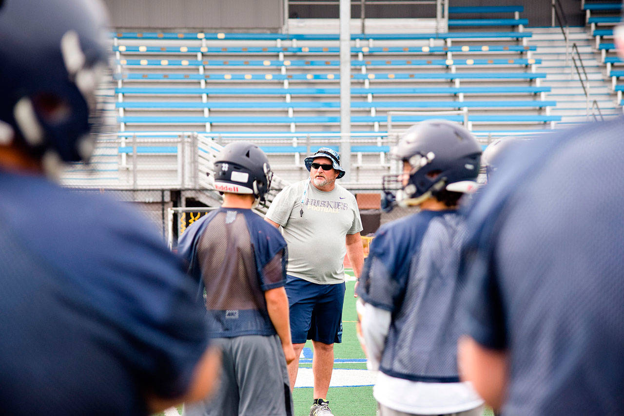 Sultan head coach Rick Rudd explains a drill to his team during a practice on Aug. 23 at Sultan High School. (Katie Webber / The Herald)
