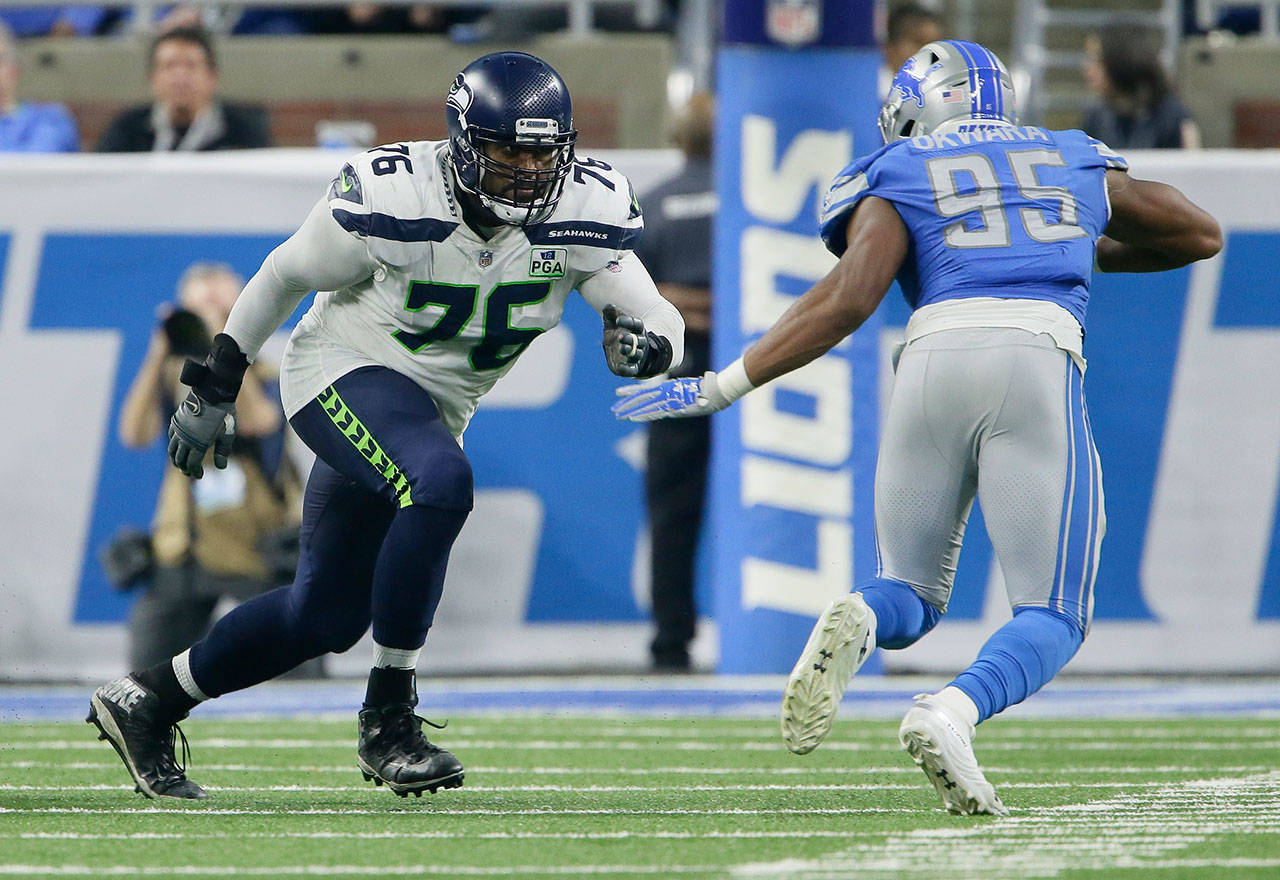 Seahawks left tackle Duane Brown (76) blocks against Lions defensive end Romeo Okwara (95) during the second half of a game on Oct. 28, 2018, in Detroit. (AP Photo/Duane Burleson)