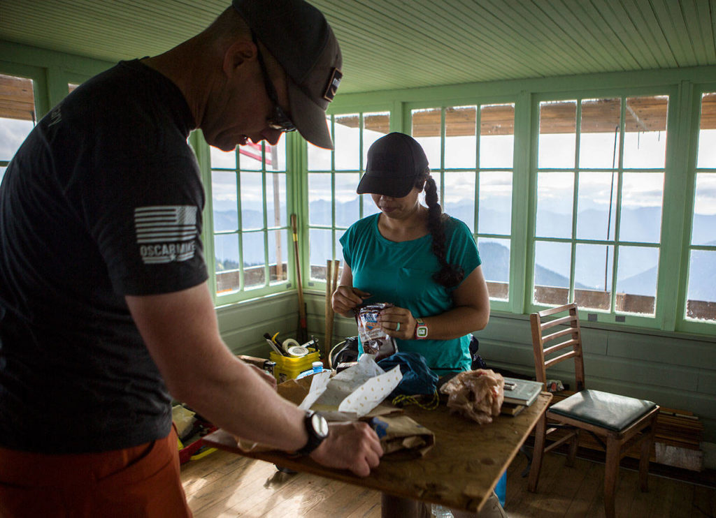 Don and Stacy Sarver prepare snacks after arriving at the Green Mountain Lookout for the weekend. (Olivia Vanni / The Herald)

