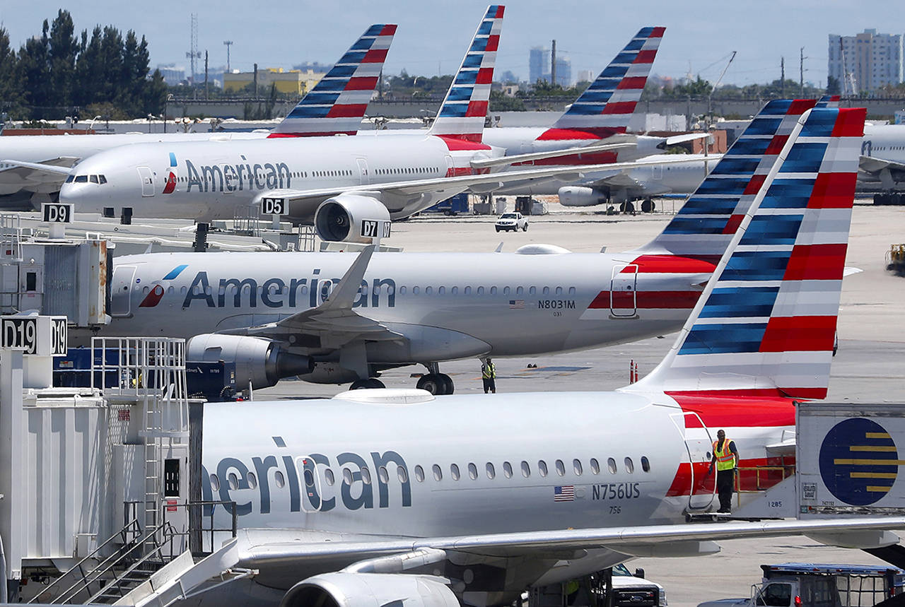 In this April 24 photo, American Airlines aircraft are shown parked at their gates at Miami International Airport in Miami. (AP Photo/Wilfredo Lee, File)