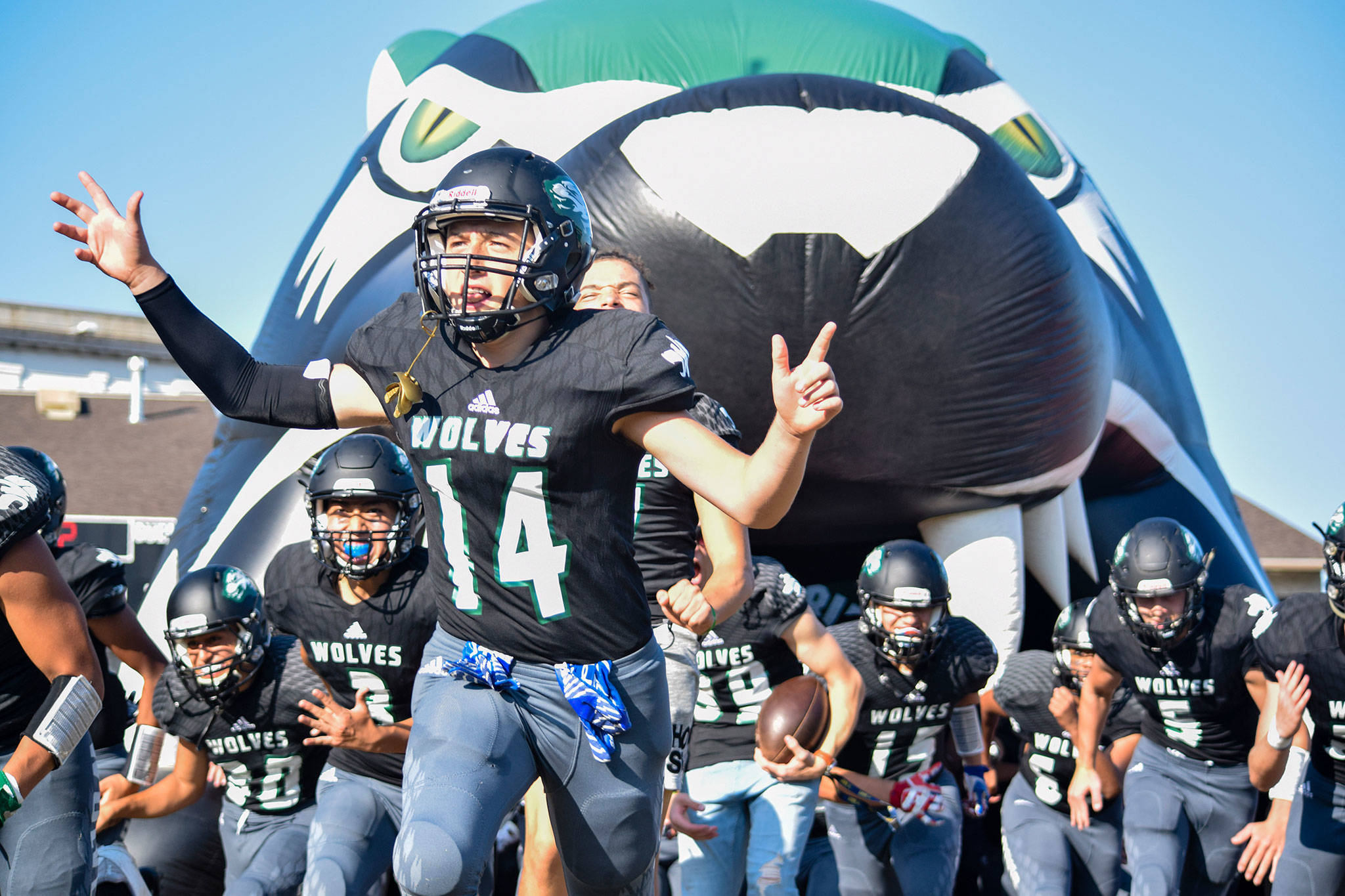Sophomore Allan Gincherman leads Jackson onto the field before the game against Stanwood on Friday at Everett Memorial Stadium. (Katie Webber / The Herald)