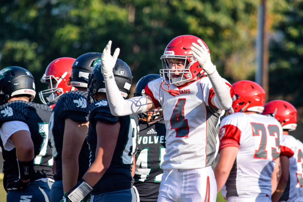 Senior defensive back AJ Larson interacts with the sideline after stopping the Jackson offense on Friday at Everett Memorial Stadium. (Katie Webber / The Herald)
