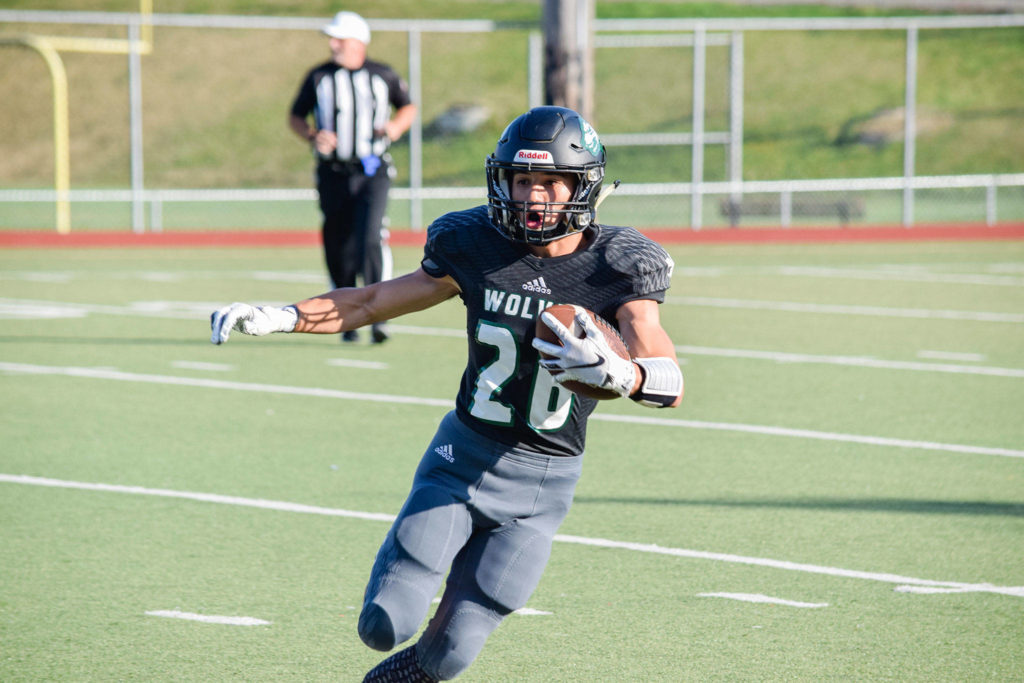 Junior running back Brendan Sandico runs for a first down against Stanwood on Friday at Everett Memorial Stadium. (Katie Webber / The Herald)
