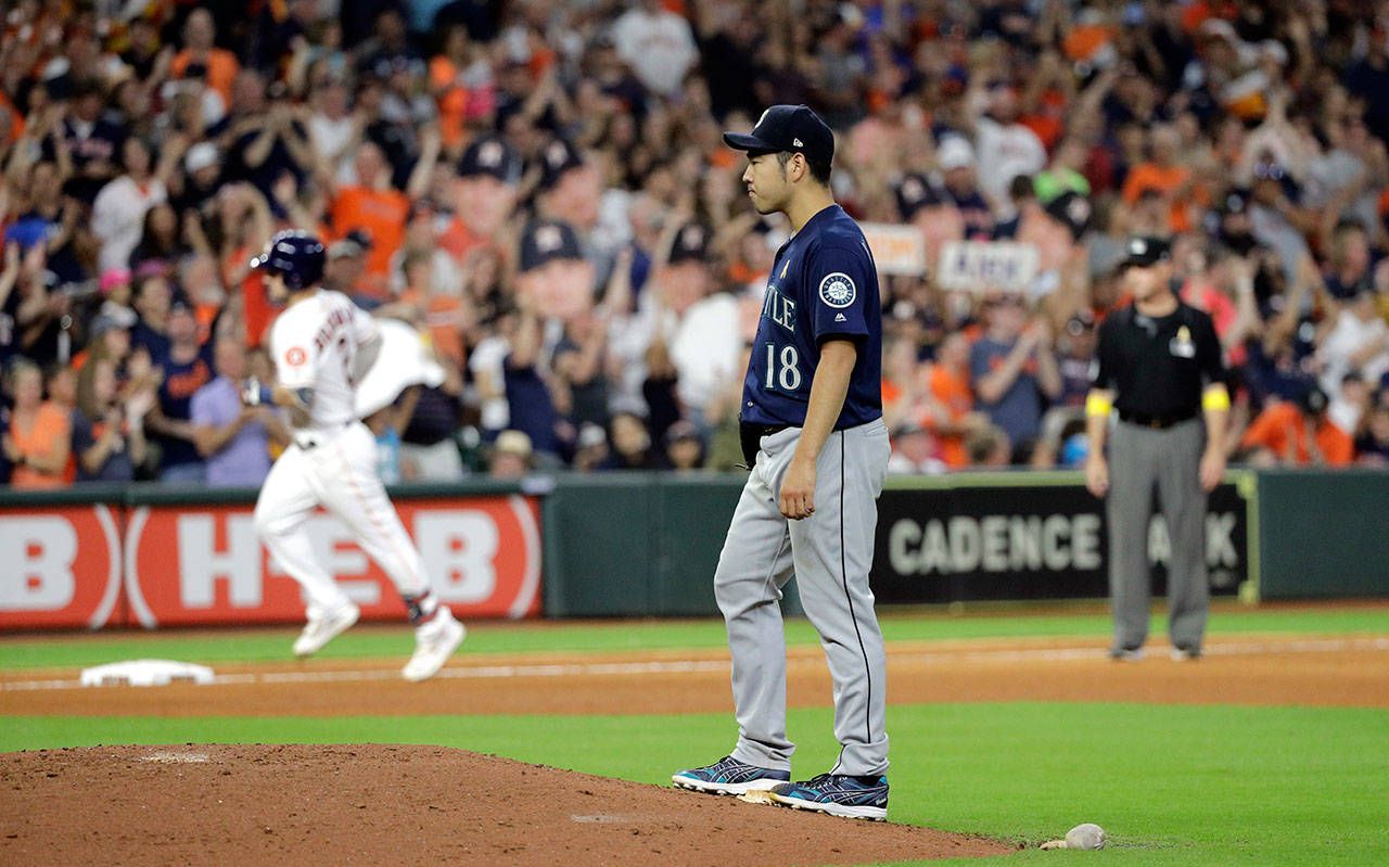 Mariners starting pitcher Yusei Kikuchi (right) stands on the back of the mound after giving up a home run to the Astros’ Alex Bregman (left) during the sixth inning of a game Sept. 7, 2019, in Houston. (AP Photo/David J. Phillip)