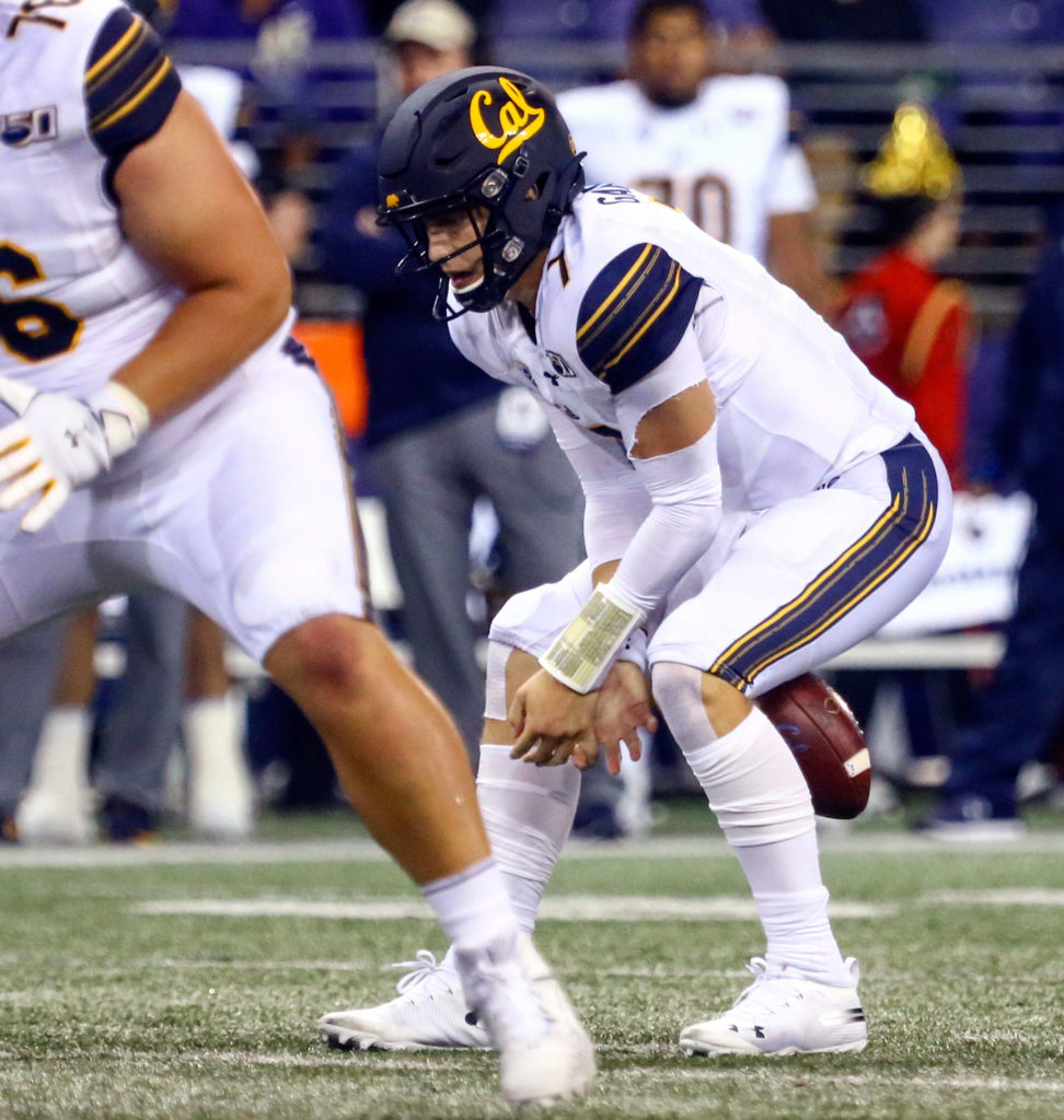 California’s Chase Garbers fumbles the snap Saturday night at Husky Stadium in Seattle on September 7, 2019.(Kevin Clark / The Herald)