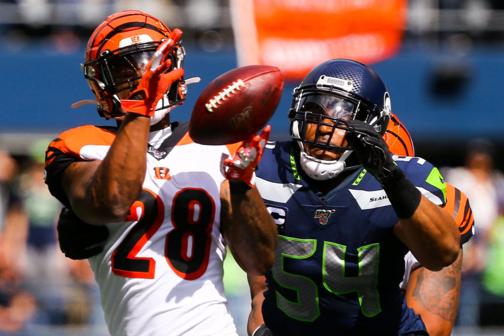 Cincinnati’s Joe Mixon makes a catch with Seattle’s Bobby Wagner closing at CenturyLink Field Sunday afternoon in Seattle on September 8, 2019.(Kevin Clark / The Herald)