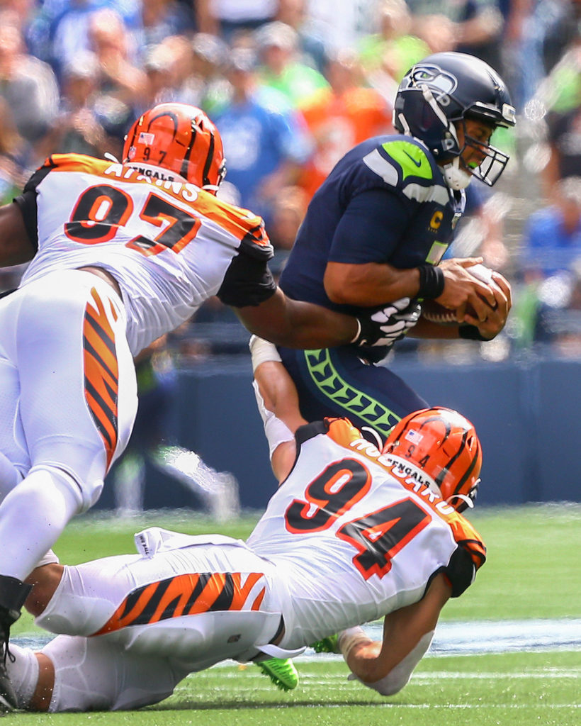 Cincinnati’s Geno Atkins and Sam Hubbard sack Seattle’s Russell Wilson at CenturyLink Field Sunday afternoon in Seattle on September 8, 2019.(Kevin Clark / The Herald)