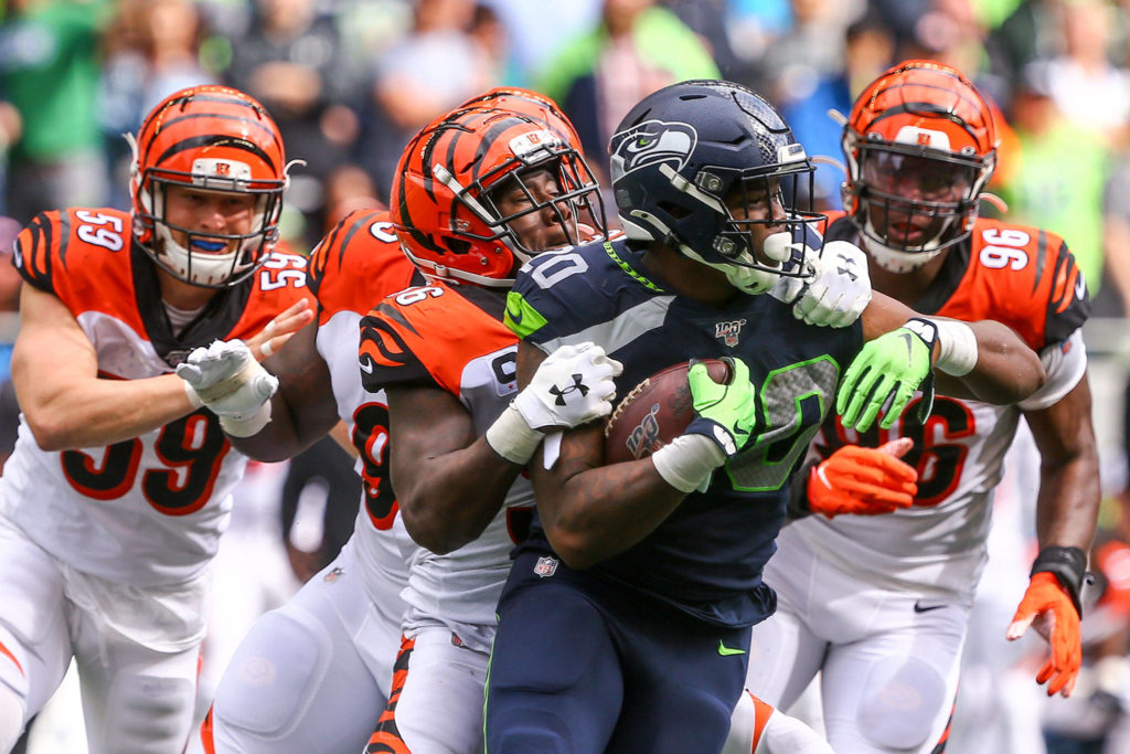 Seattle’s Rashaad Penny trailed by Cincinnati defenders at CenturyLink Field Sunday afternoon in Seattle on September 8, 2019. The Seahawks won 21-20. (Kevin Clark / The Herald)
