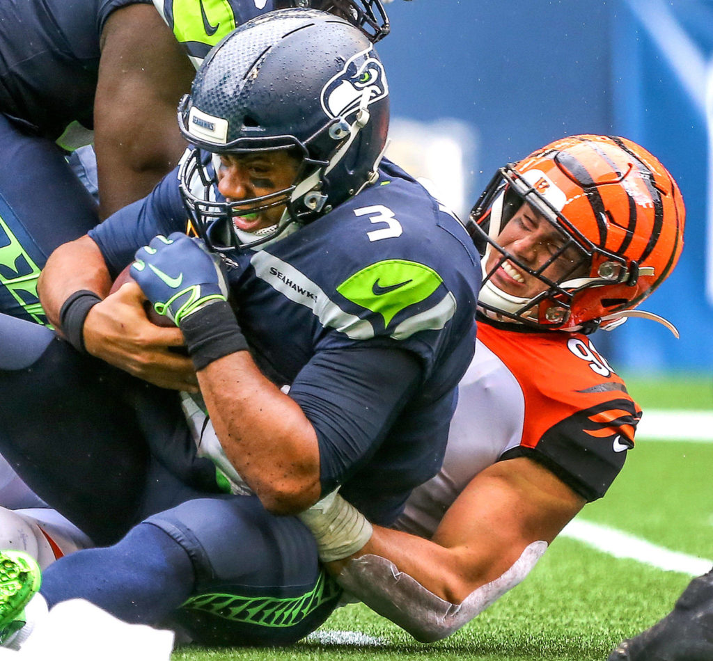Seattle’s Russell Wilson is sacked by Cincinnati’s Sam Hubbard at CenturyLink Field Sunday afternoon in Seattle on September 8, 2019. The Seahawks won 21-20. (Kevin Clark / The Herald)
