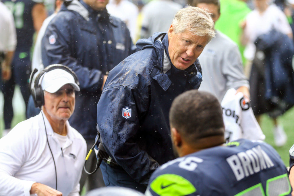Seattle ‘s head coach Pete Carroll talks with offensive line after two straight sacks at CenturyLink Field Sunday afternoon in Seattle on September 8, 2019. The Seahawks won 21-20. (Kevin Clark / The Herald)
