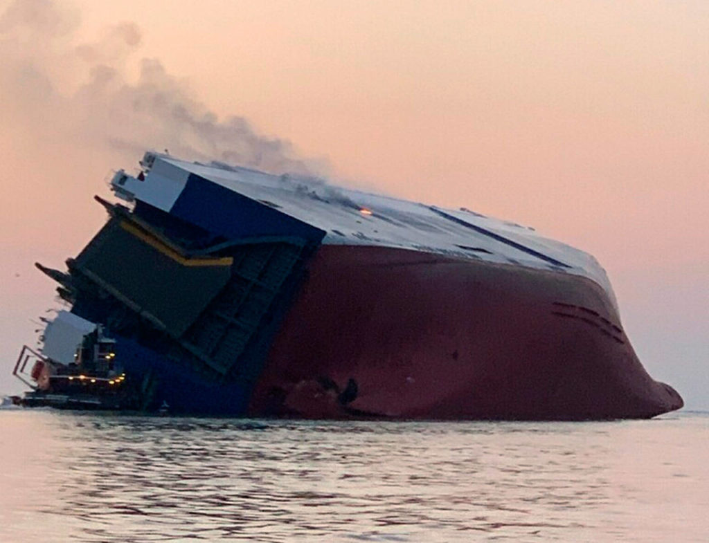 An overturned cargo vessel burns Sunday in St. Simons Sound, Georgia. (U.S. Coast Guard)
