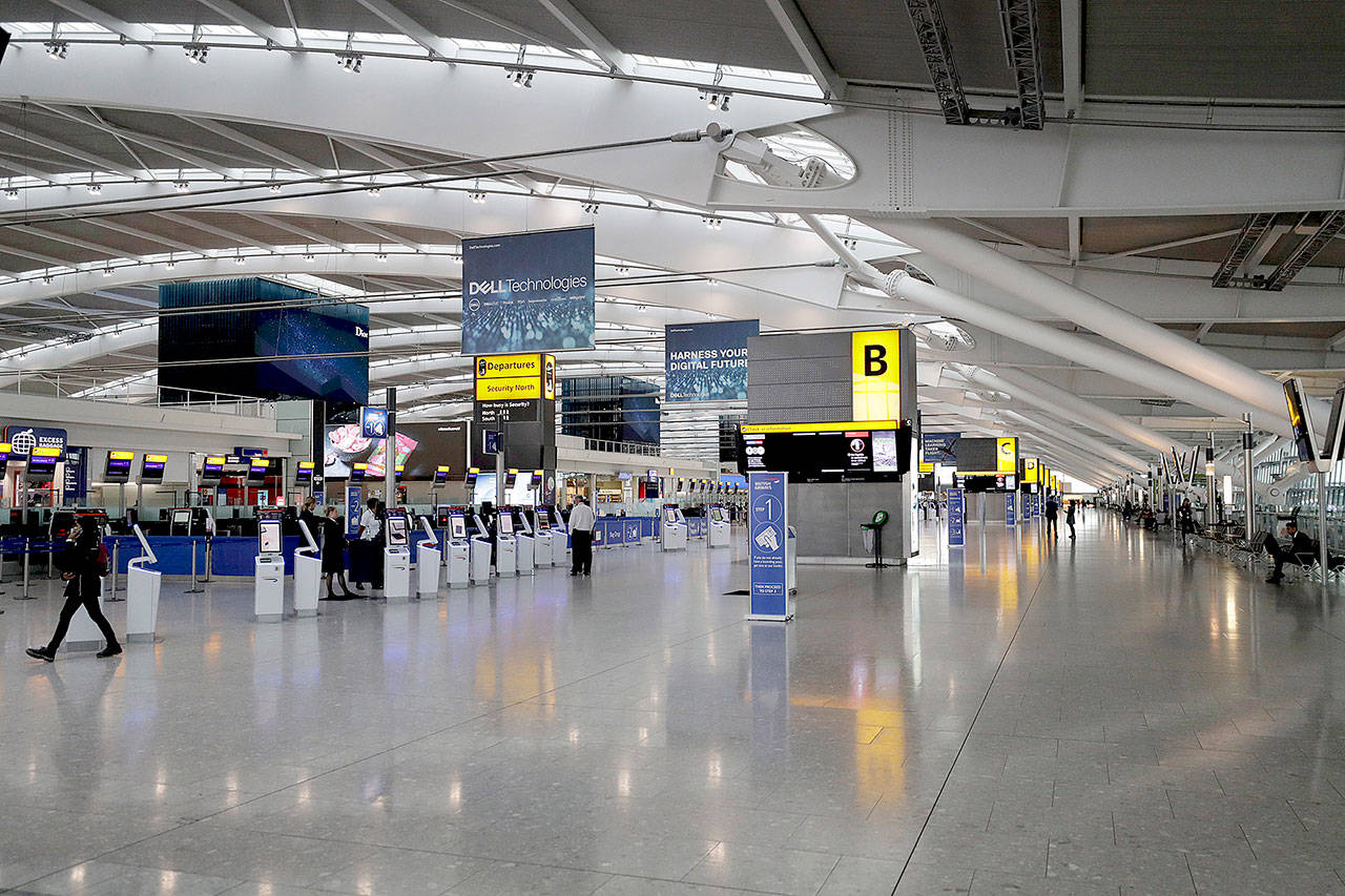 Terminal 5 at Heathrow Airport in London, which handles British Airways flights, was virtually empty of passengers Monday. (AP Photo/Matt Dunham)