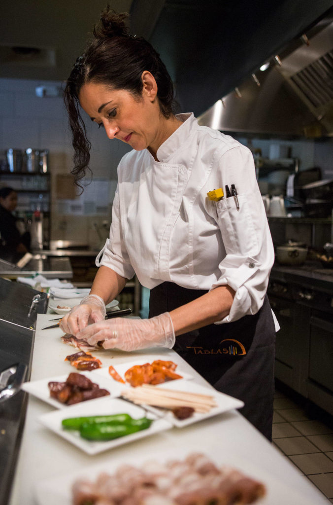 Executive chef and part owner Clara Gutierrez Carroll works in the kitchen at Tablas Woodstone Taverna in Mill Creek. (Olivia Vanni / The Herald)
