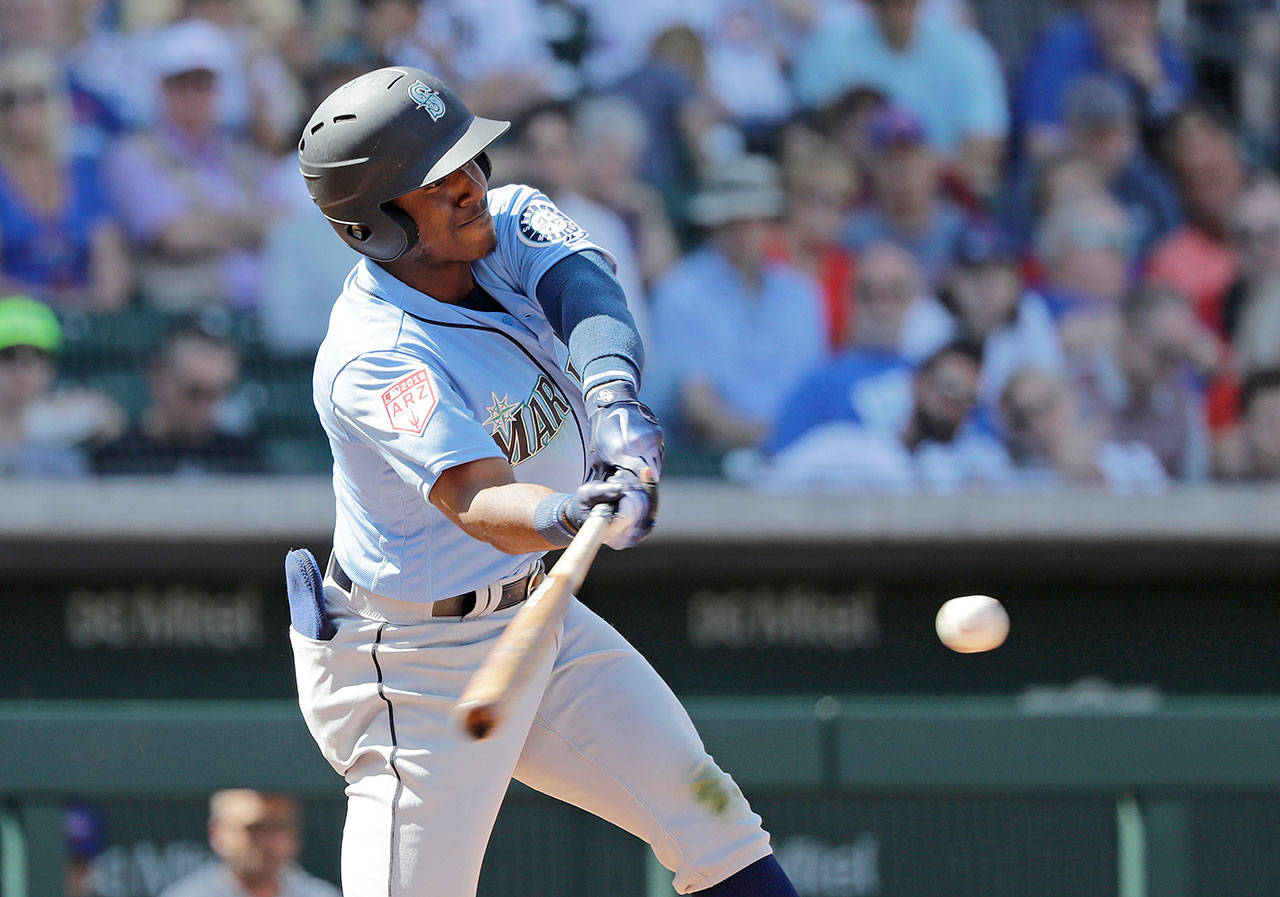Seattle’s Kyle Lewis swings during a March 19 spring training game against the Chicago Cubs in Mesa, Arizona. (AP Photo/Elaine Thompson)