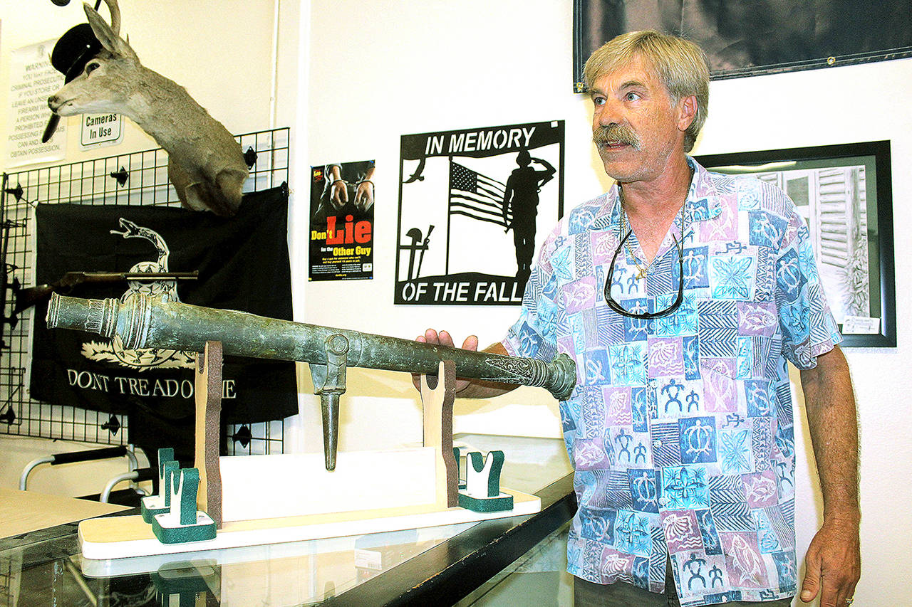 Picker John Norris shows off circa 1600s cannon discovered in abandoned storage locker. (Wendy Leigh / South Whidbey Record)