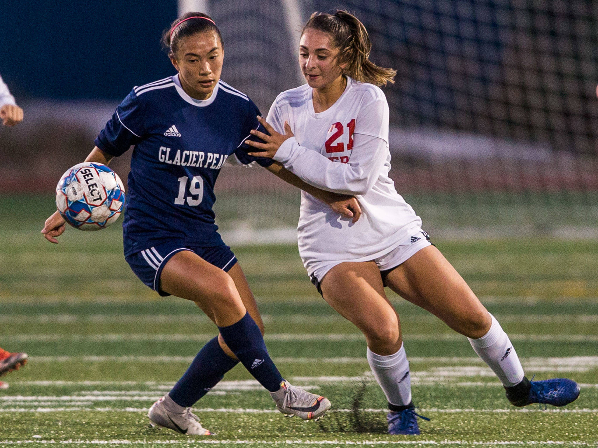 Glacier Peak’s Emily Strong (left) and Snohomish’s Ravyn Mummey fight for the ball during a non-conference girls soccer game Tuesday at Glacier Peak High School in Snohomish. (Olivia Vanni / The Herald)