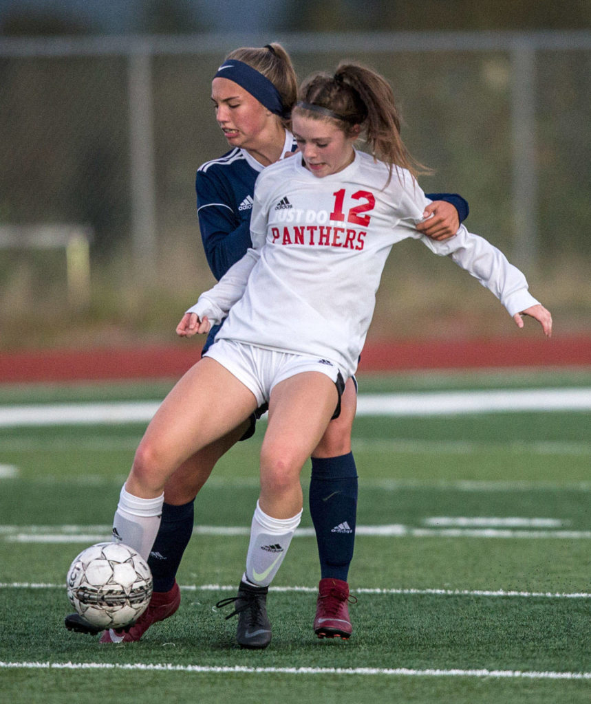 Snohomish’s Cheyenne Rodgers battles with a Glacier Peak defender for control of the ball during a non-conference girls soccer game Tuesday at Glacier Peak High School in Snohomish. (Olivia Vanni / The Herald)
